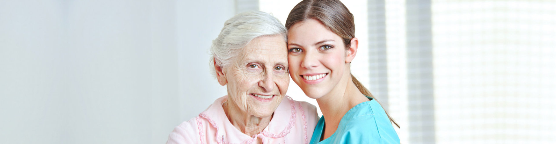 senior woman with female caregiver smiling